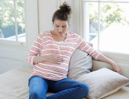 pregnant woman stroking her bump