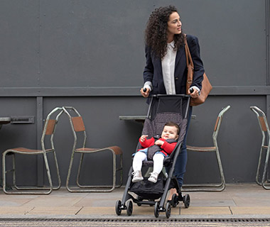 mum pushing a mothercare stroller pushchair