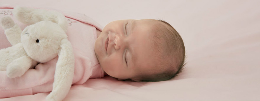 baby fast asleep in their cot